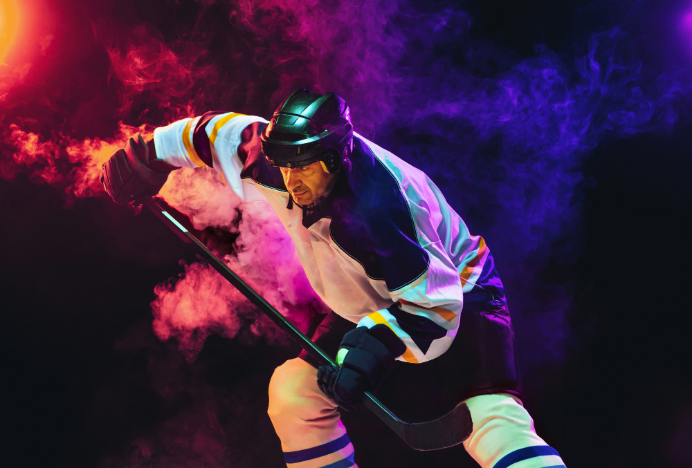 male hockey player with stick ice court dark neon colored wall